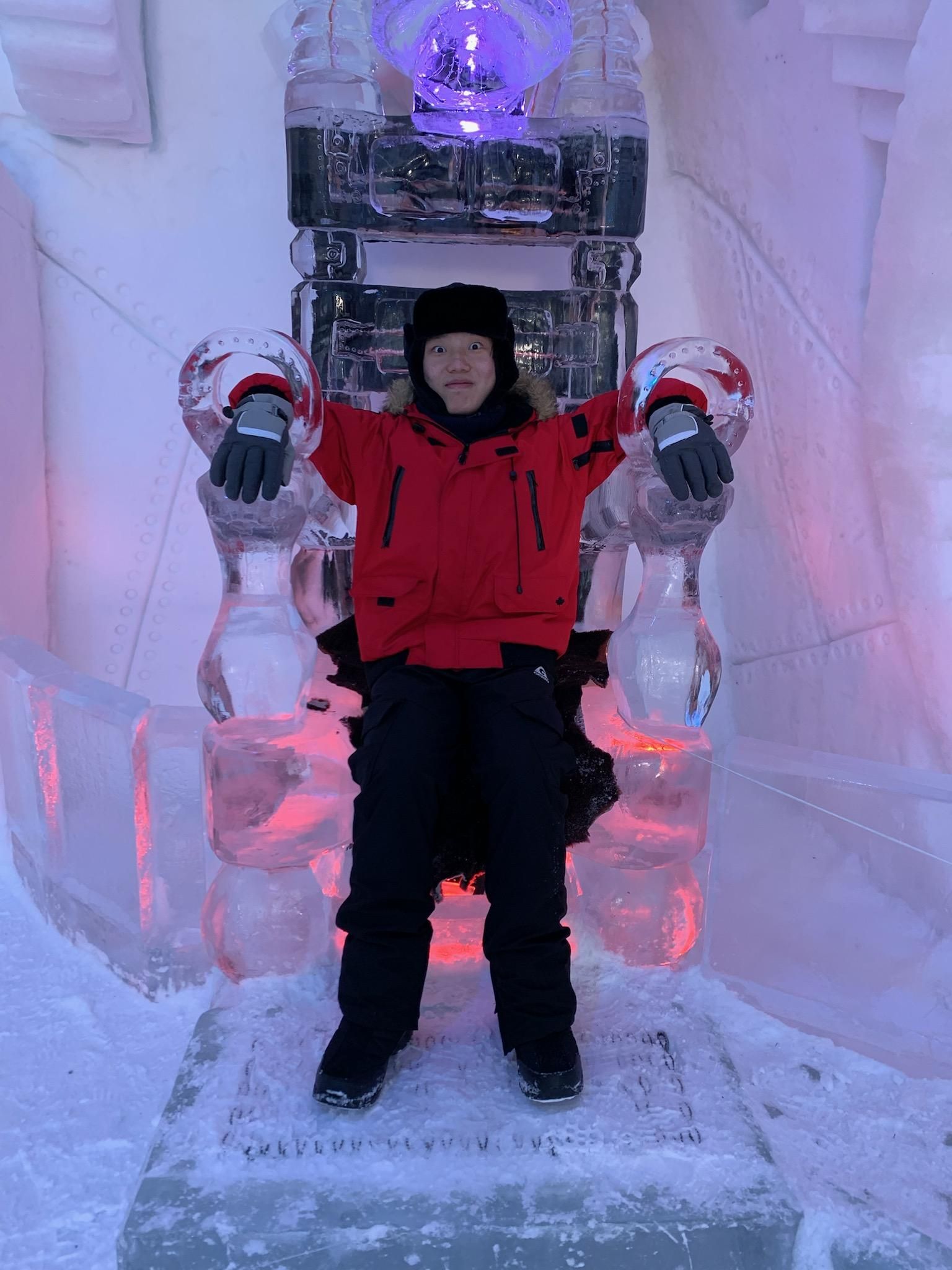 Owen Wang sitting on an ice sculpture